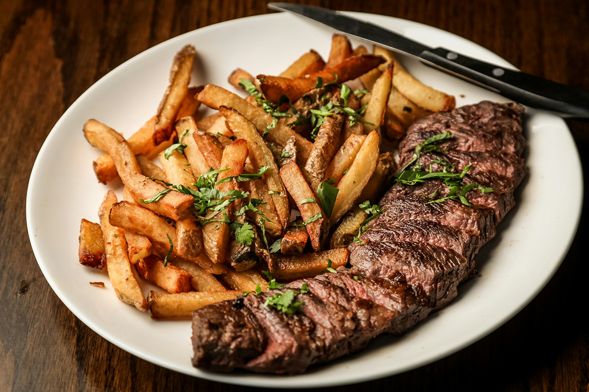 Steak and chips on a white plate